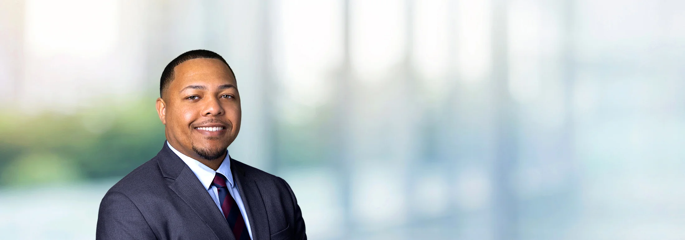 A photo of attorney, Evan Coleman, against a softly blurred office background.