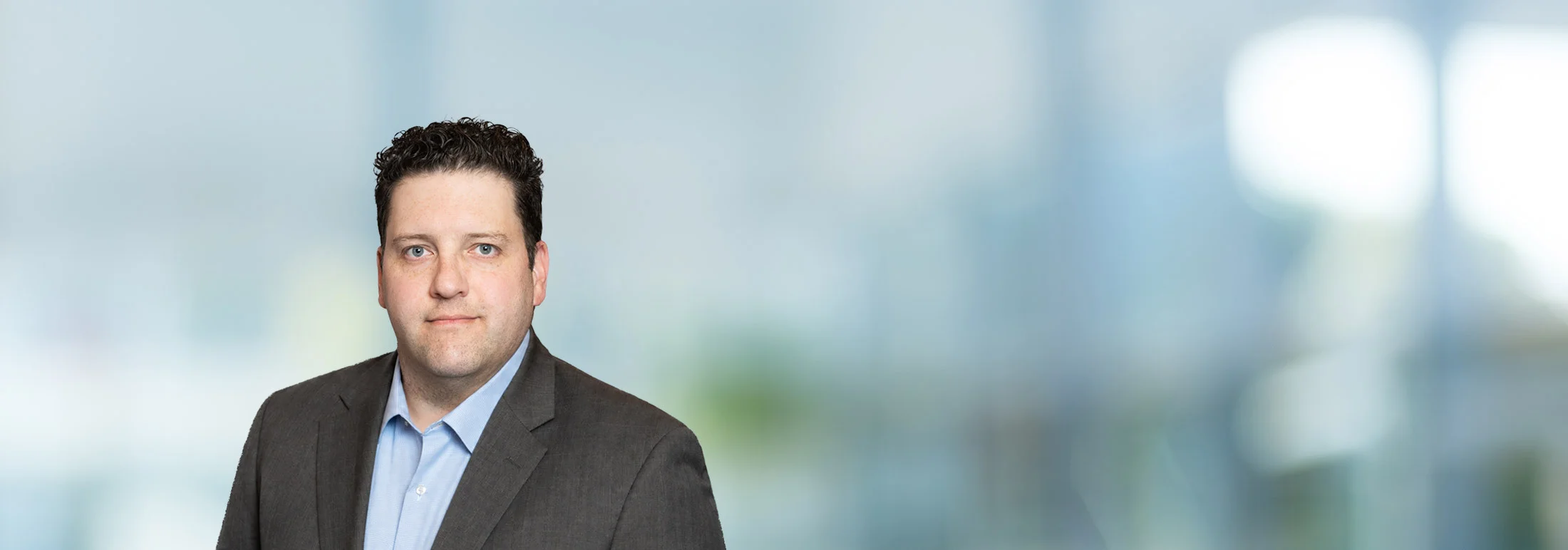 A photo of attorney Justin Shiroff against a softly blurred office background