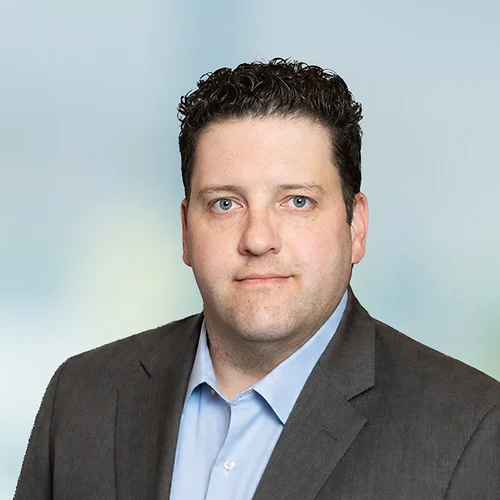 A photo of attorney Justin Shiroff against a softly blurred office background