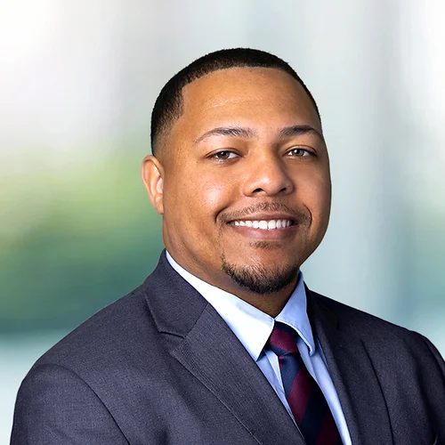 A photo of attorney, Evan Coleman, against a softly blurred office background.