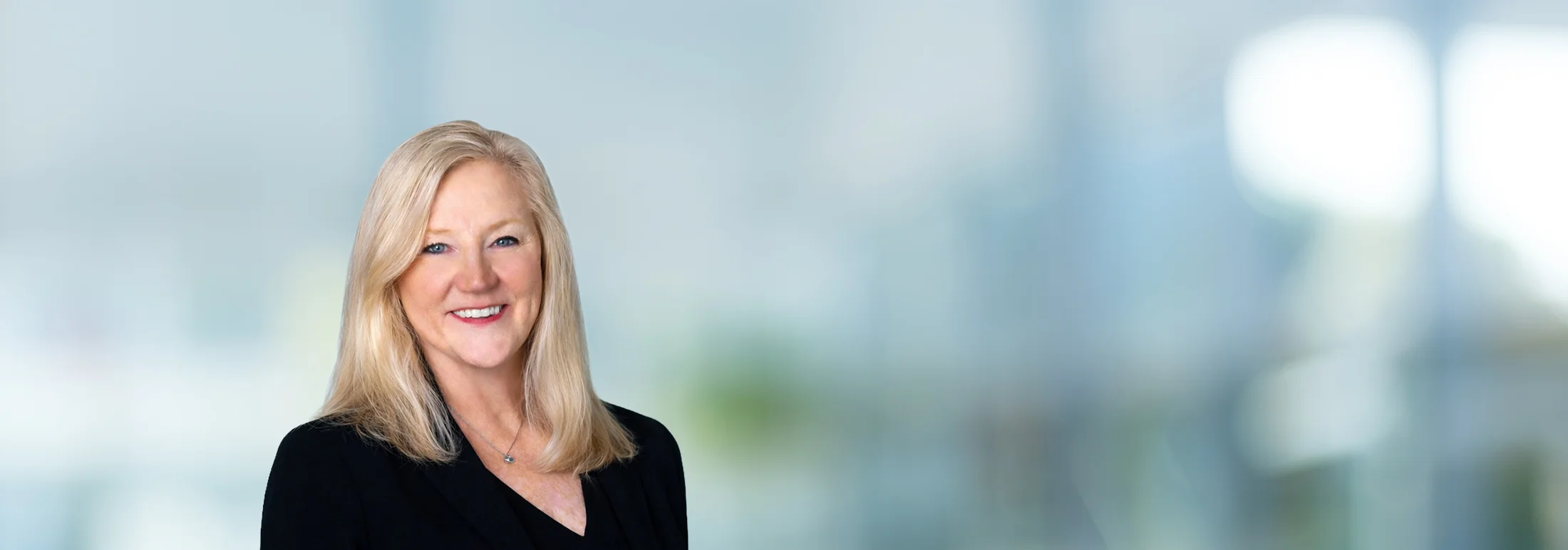 A photo of attorney, Jessica Kennedy, against a softly blurred office background.