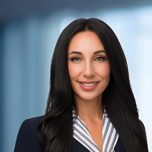 A photo of attorney, Kimya Liaghat, against a softly blurred office background