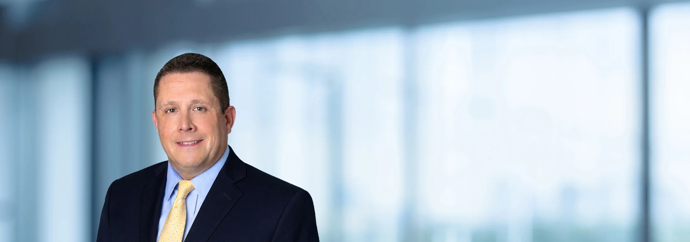 A photo of attorney, John Young, against a softly blurred office background.