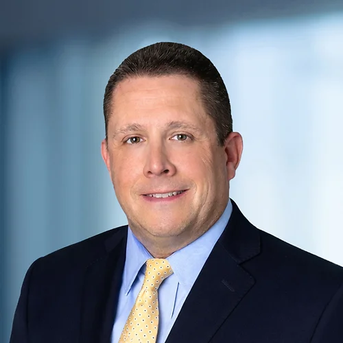 A photo of attorney, John Young, against a softly blurred office background.