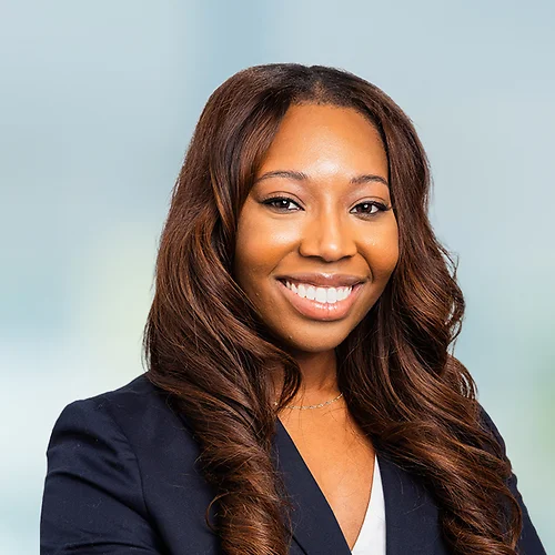A photo of attorney, Dominique Caldwell, against a softly blurred office background.