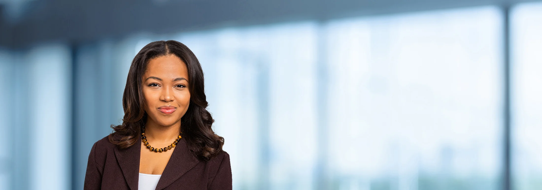 A photo of attorney, Candice Diah-Okyar, against a softly blurred office background.