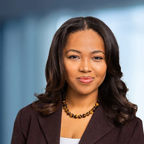 A photo of attorney, Candice Diah-Okyar, against a softly blurred office background.
