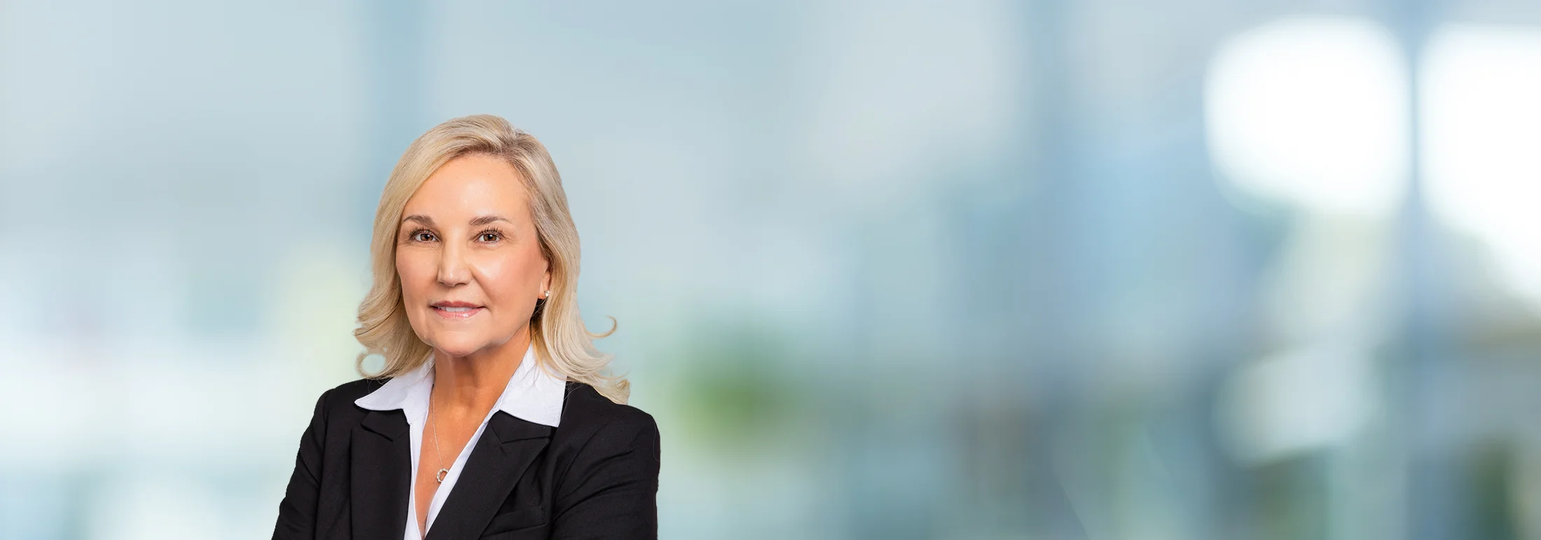 A photo of attorney, Hannah Symonds, against a softly blurred office background.