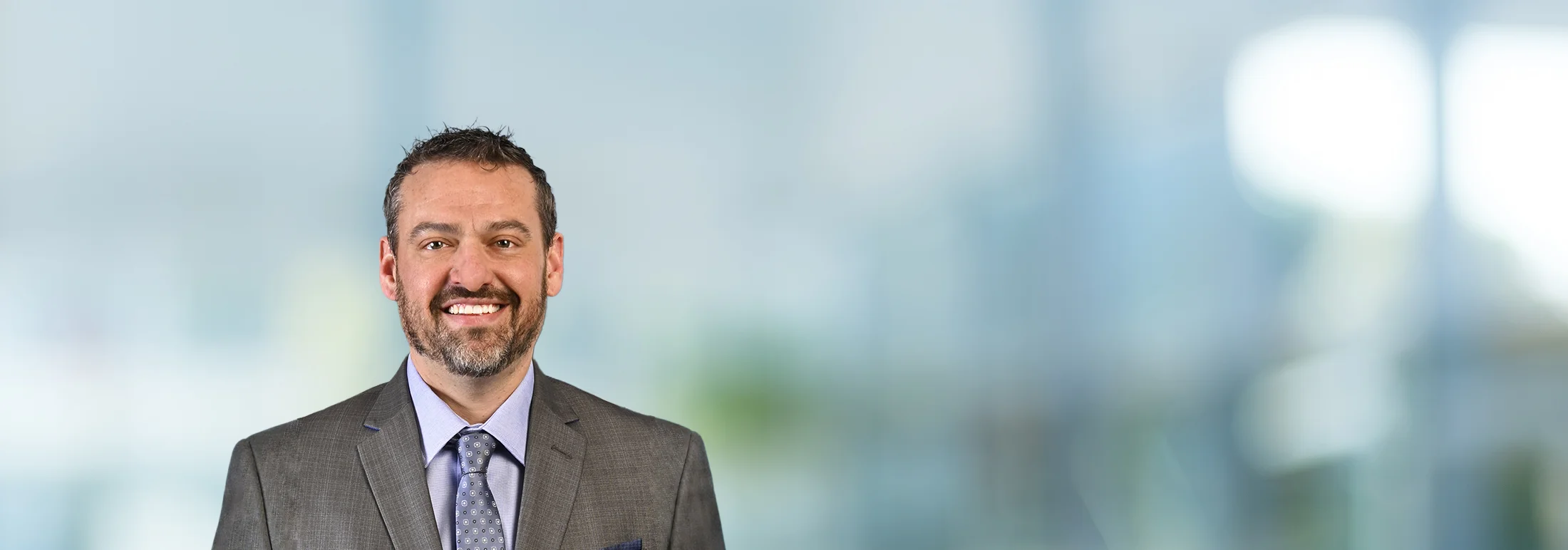 A photo of attorney, Jamey Davidson, against a softly blurred office background.