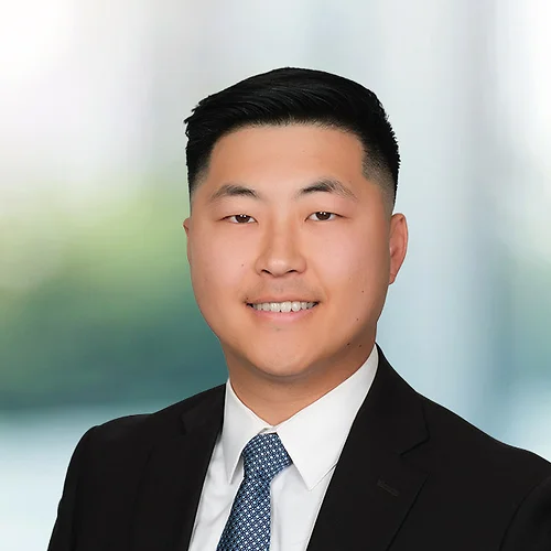 A photo of attorney Justin Kim against a softly blurred office background.