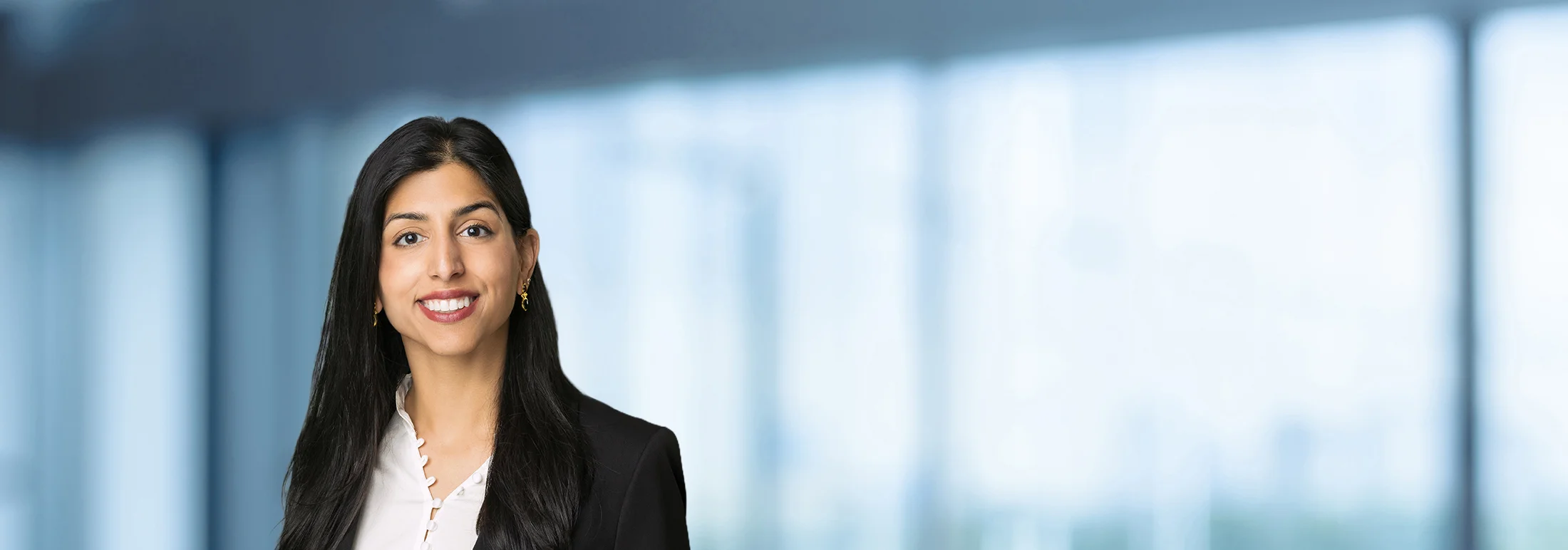 A photo of attorney, Iman Eikram, against a softly blurred office background.