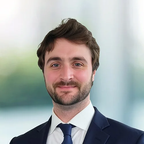 A photo of attorney John Toomey against a softly blurred office background