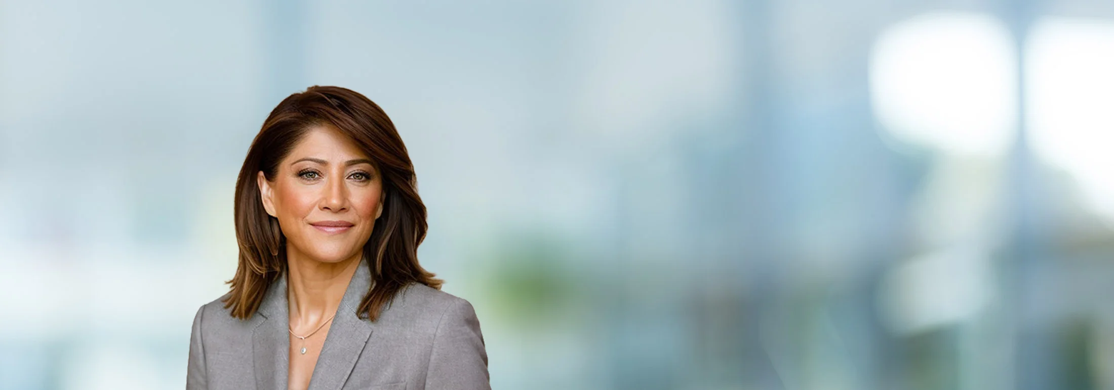 A photo of attorney Berta Blen against a softly blurred office background.