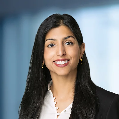 A photo of attorney, Iman Eikram, against a softly blurred office background.