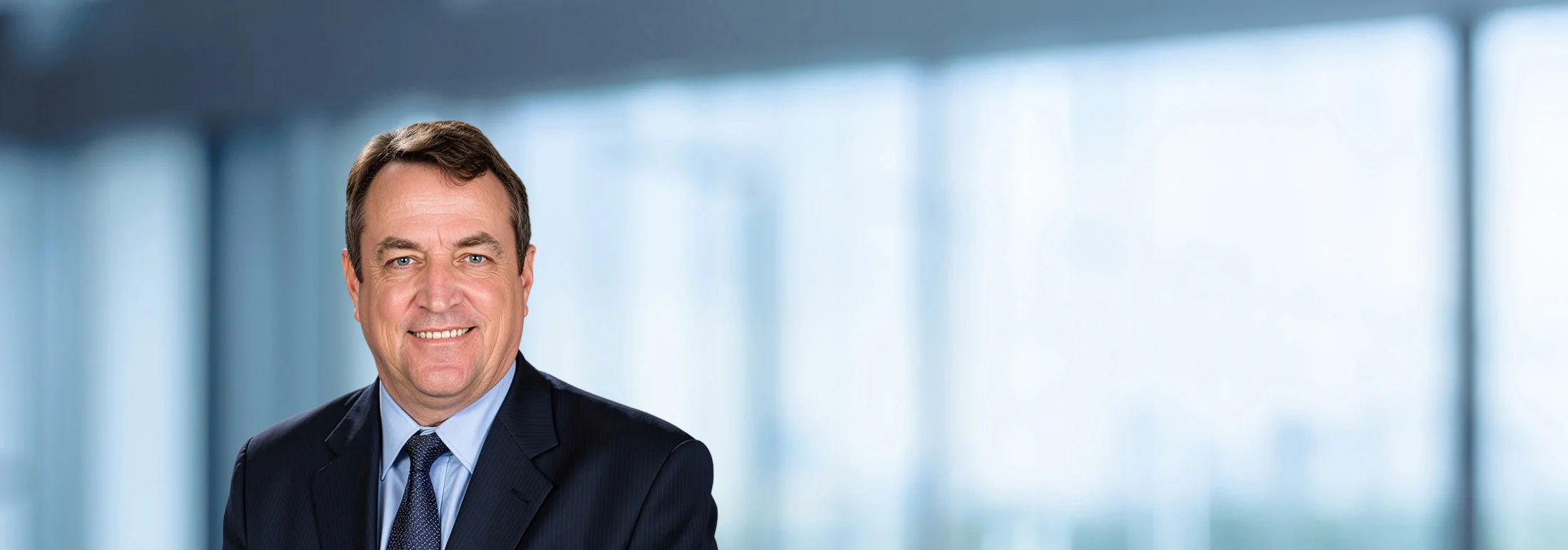 A photo of attorney Sam Edgerton against a softly blurred office background