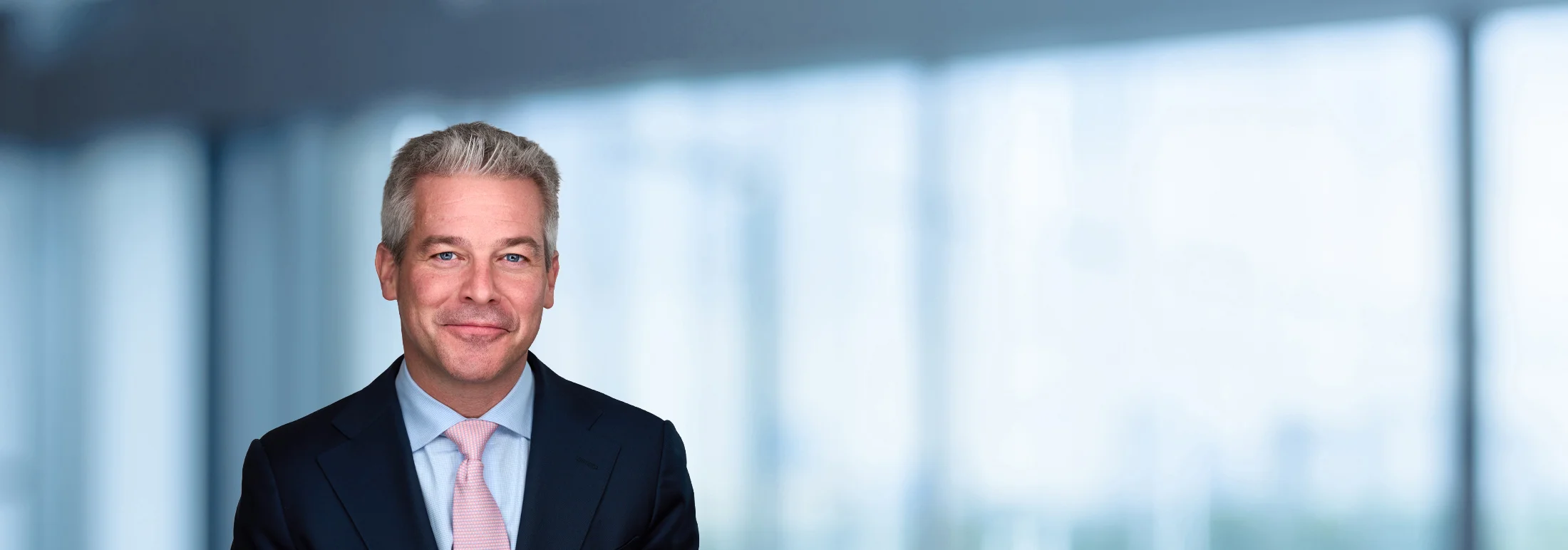 A photo of attorney Matthew Peters against a softly blurred office background