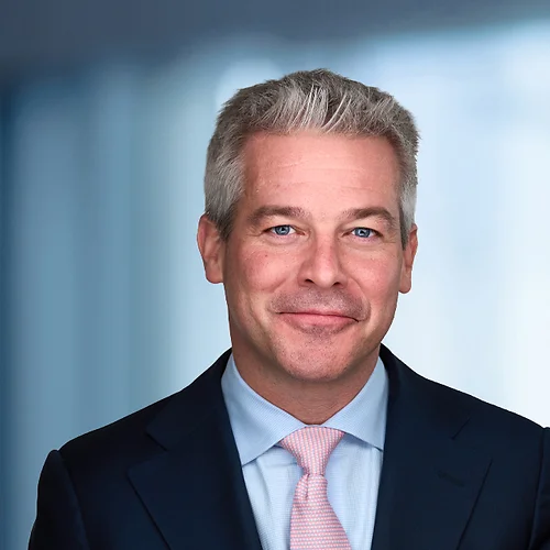 A photo of attorney Matthew Peters against a softly blurred office background