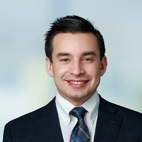A photo of attorney, Sam Fenton, against a softly blurred office background.