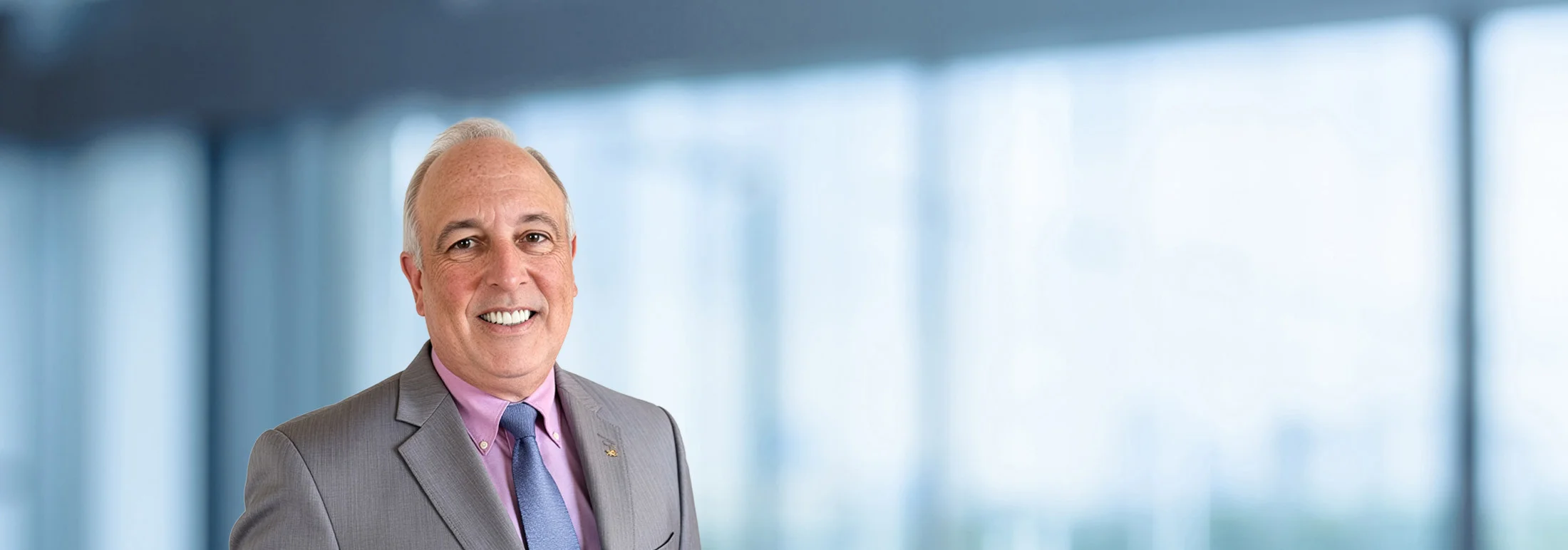 A photo of attorney Tom Shumaker against a softly blurred office background