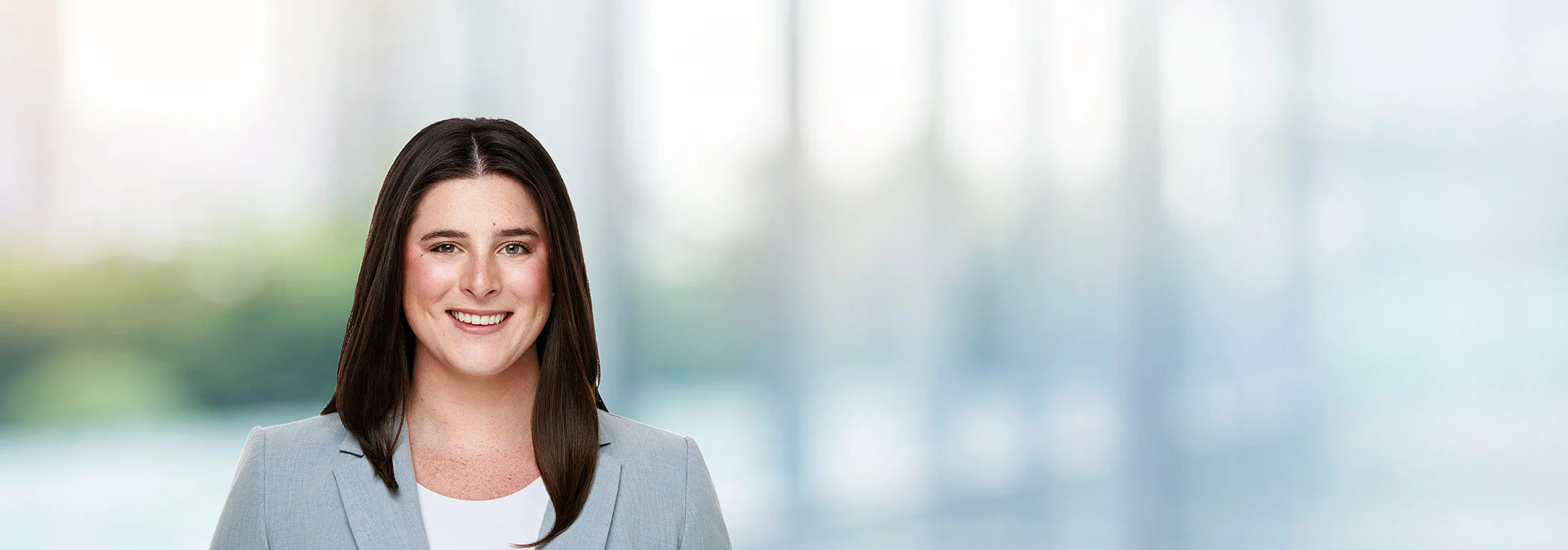 A photo of attorney Emily Callam against a softly blurred office background