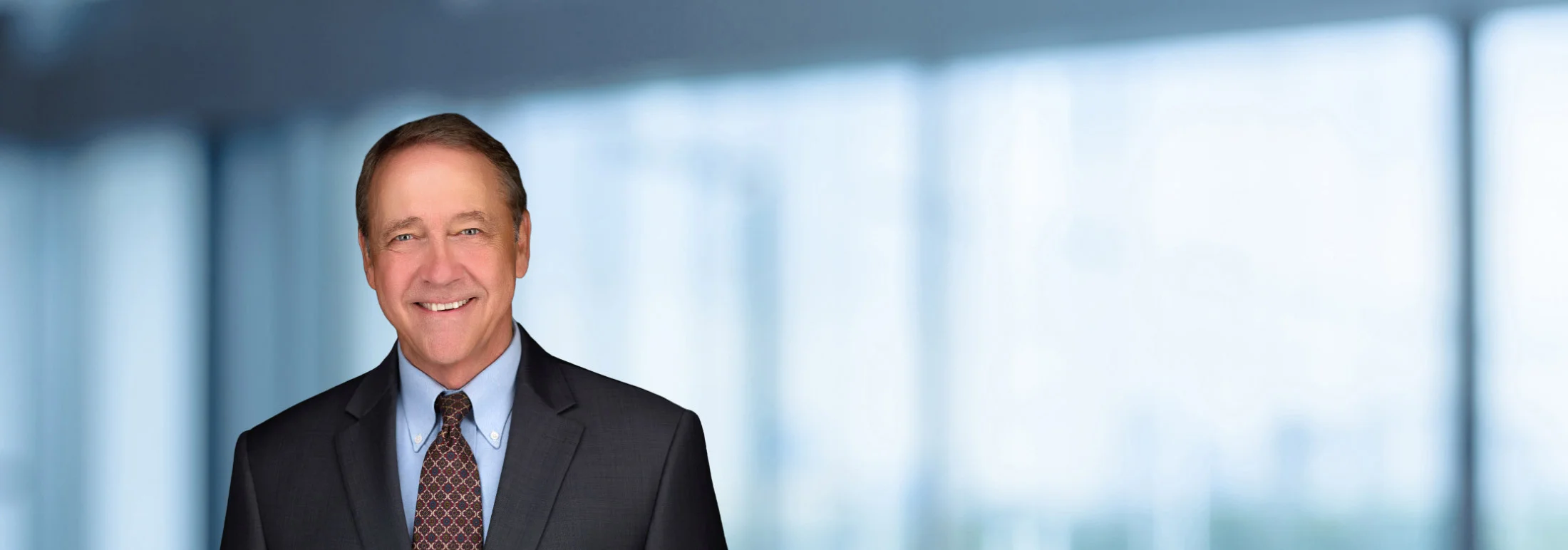 A photo of attorney John Lamb against a softly blurred office background