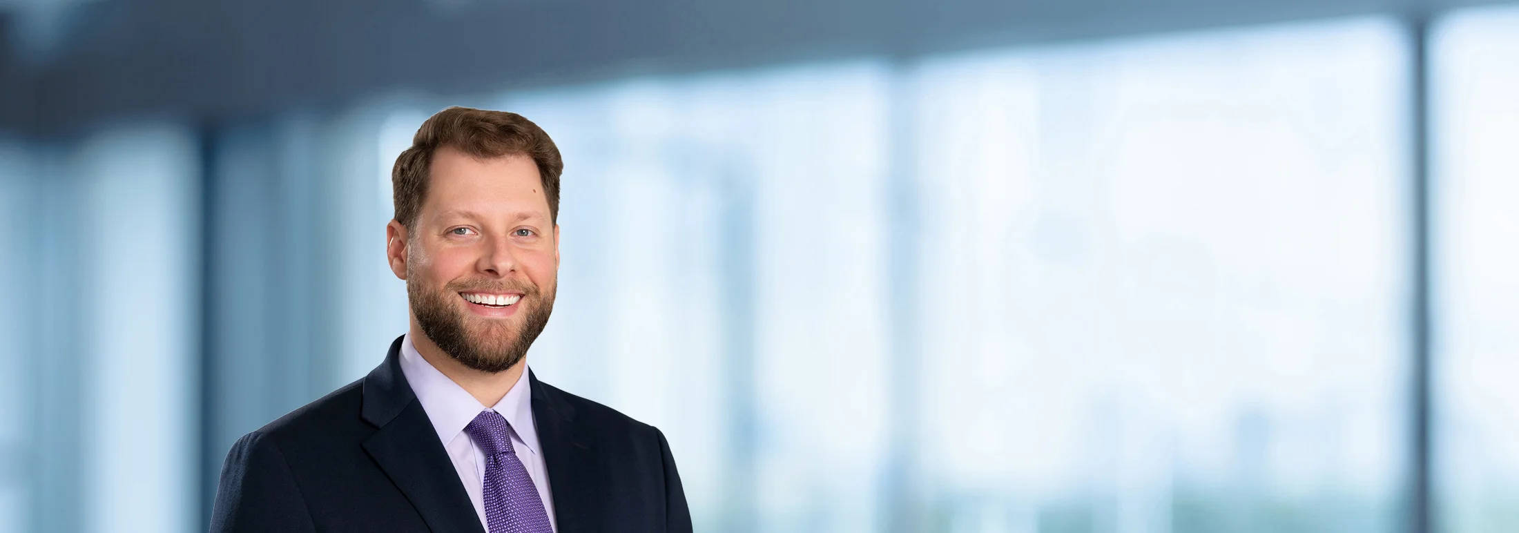 A photo of attorney Marcus Barone against a softly blurred office background