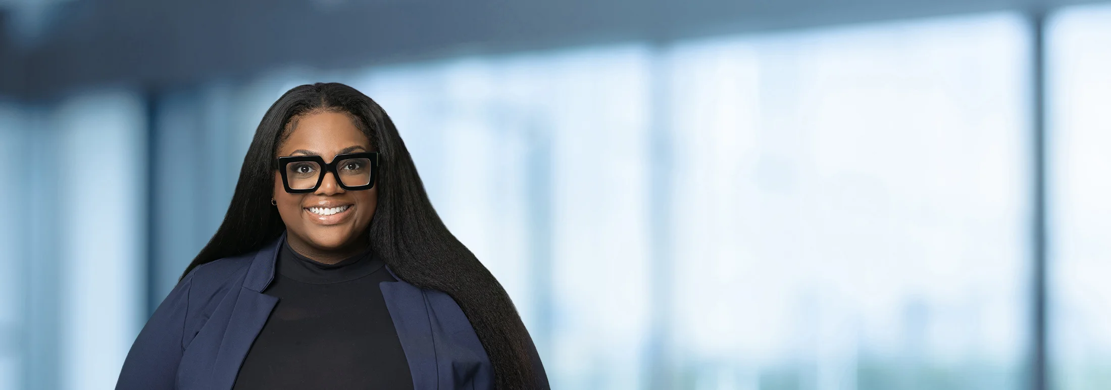 A photo of attorney, Briyana Hood, against a softly blurred office background.