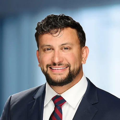 A photo of attorney Ryan Patino against a softly blurred office background