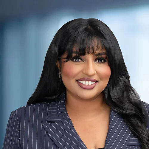A photo of attorney Ujala Batool against a softly blurred office background