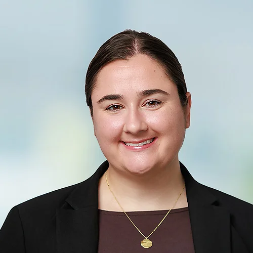 A photo of attorney Hannah Koropp against a softly blurred office background