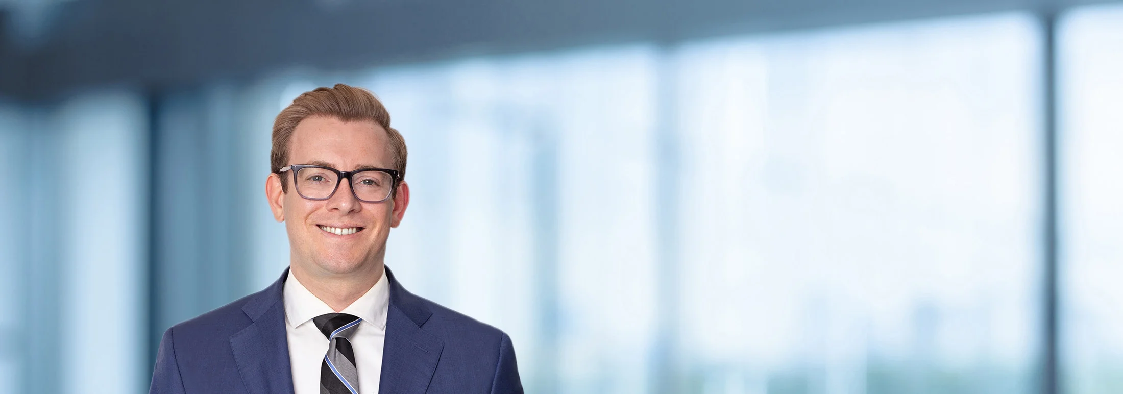 A photo of attorney Geoff Dickhaut against a softly blurred office background