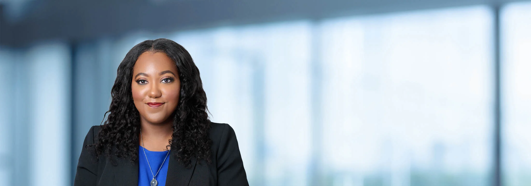 A photo of attorney Latrice Burks-Palmerio against a softly blurred office background
