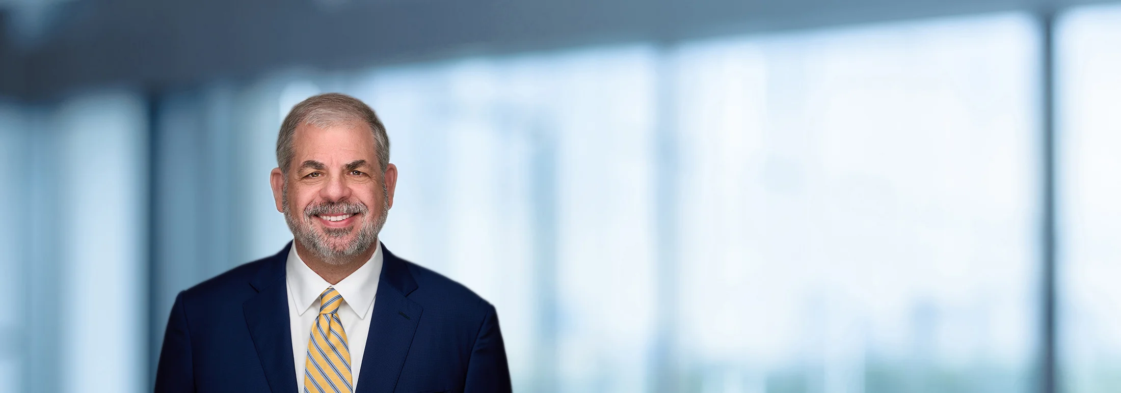 A photo of attorney John Meehan against a softly blurred office background