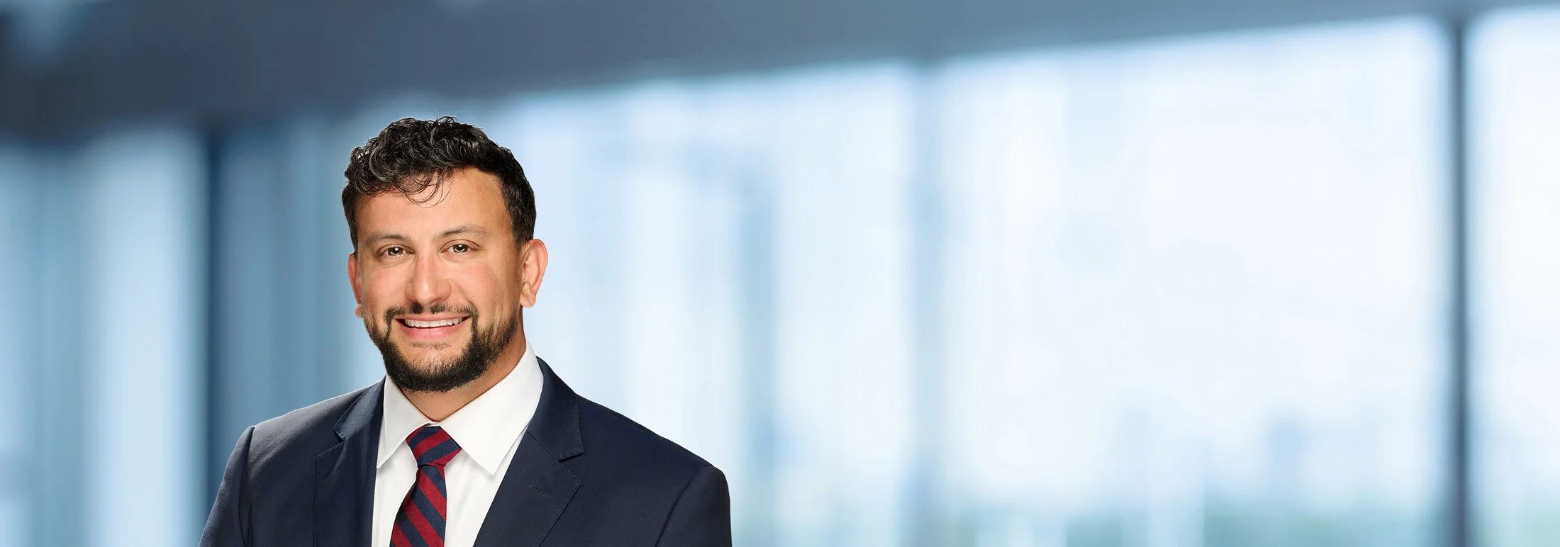 A photo of attorney Ryan Patino against a softly blurred office background