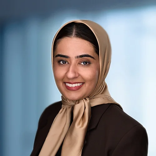 A photo of attorney Tazeen Hussain against a softly blurred office background