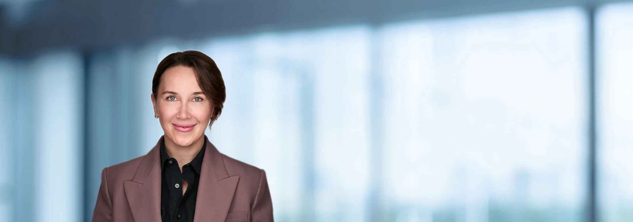A photo of attorney Maria Khusainova against a softly blurred office background