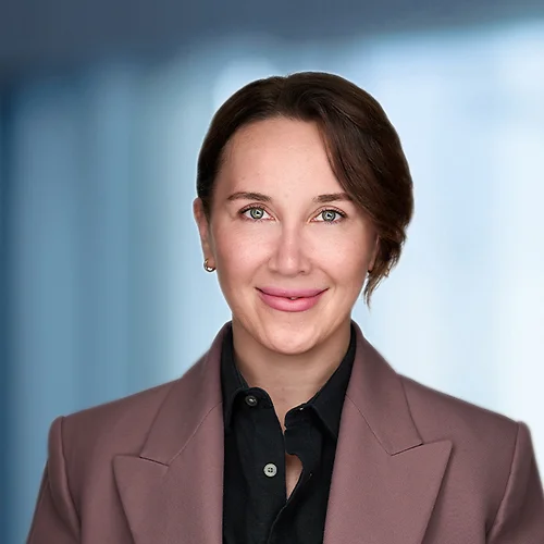 A photo of attorney Maria Khusainova against a softly blurred office background