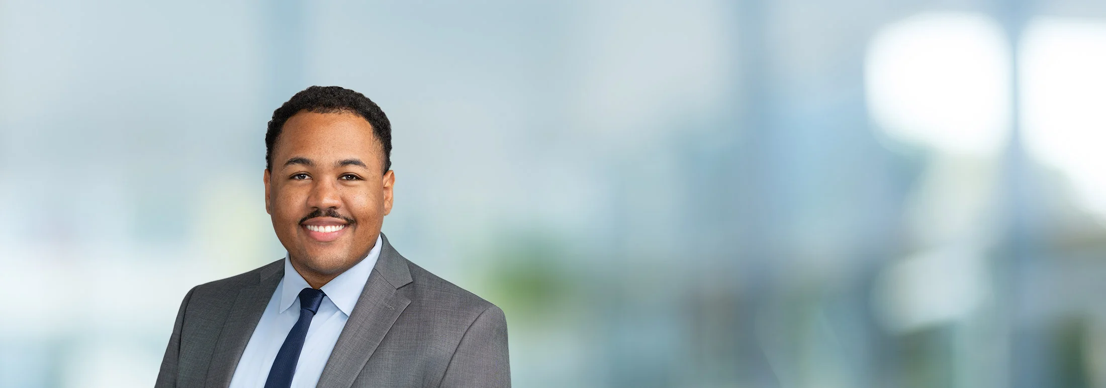 A photo of attorney Isaiah Crosby against a softly blurred office background