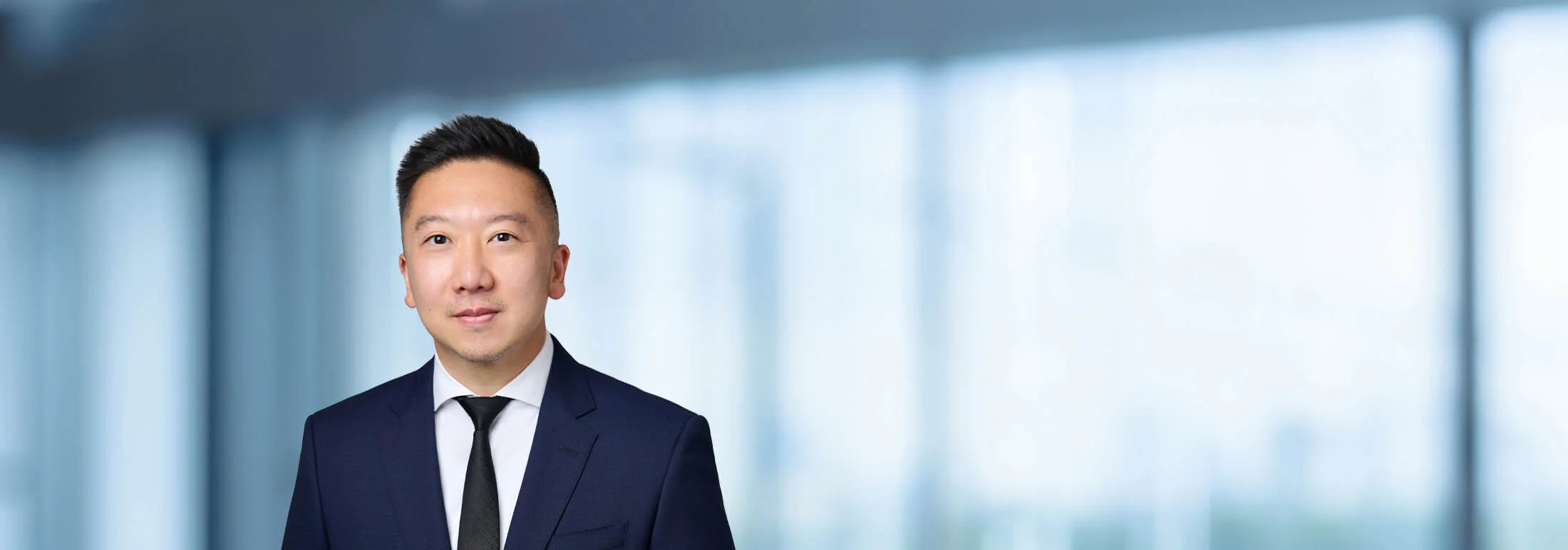 A photo of attorney Brian Lee against a softly blurred office background