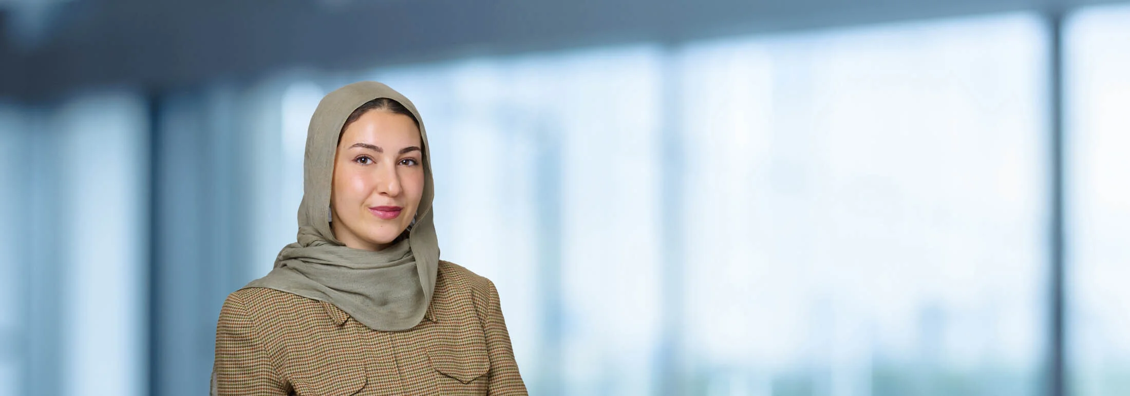A photo of attorney Maryam Bacaloni against a softly blurred office background