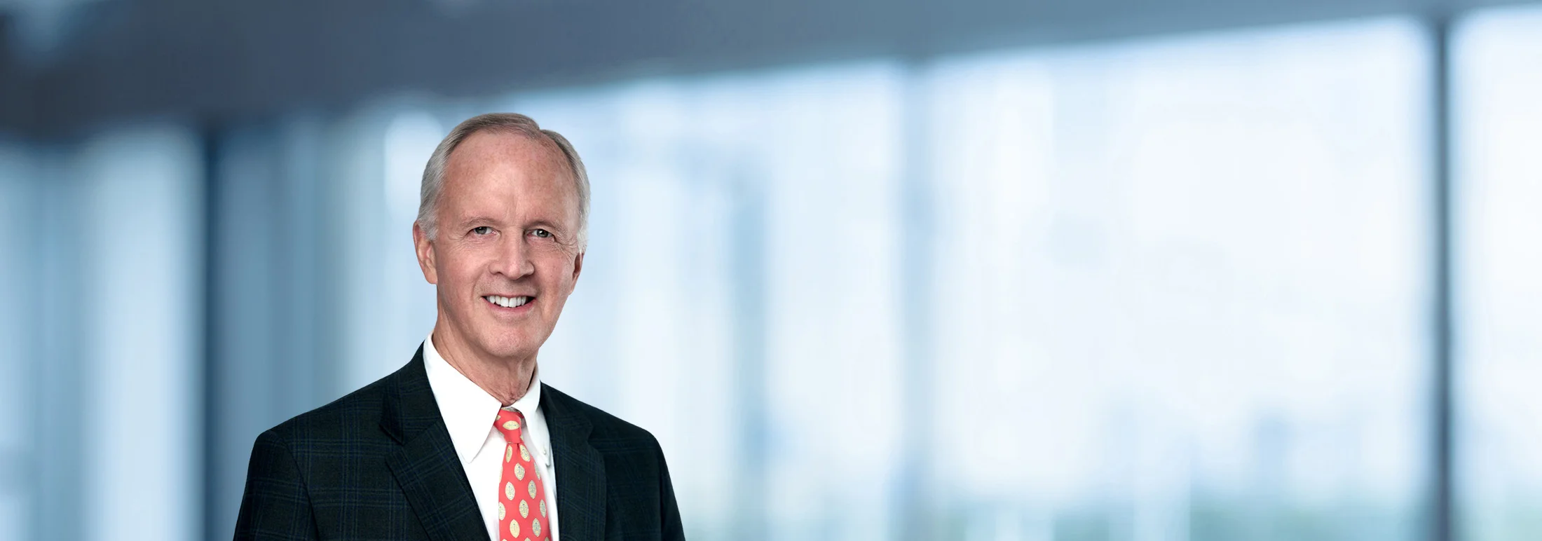 A photo of attorney Hobie Andrews against a softly blurred office background