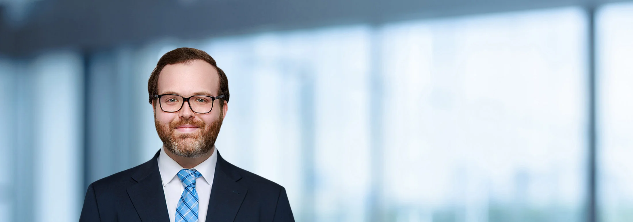 A photo of attorney Thomas Bishop against a softly blurred office background