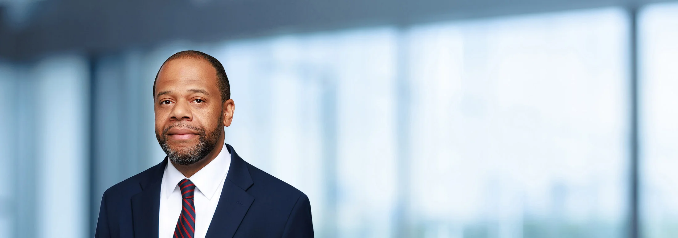 A photo of attorney Damarr Butler against a softly blurred office background