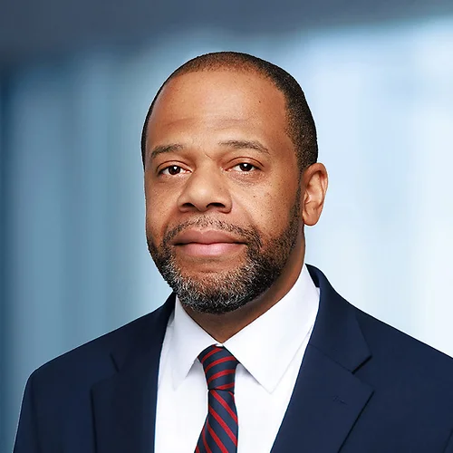 A photo of attorney Damarr Butler against a softly blurred office background