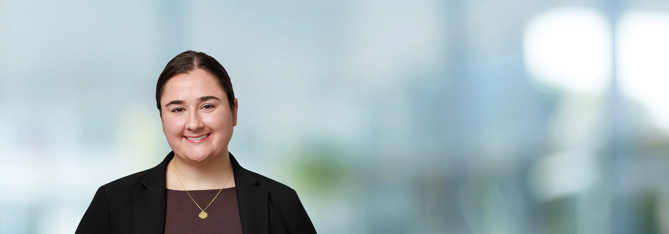A photo of attorney Hannah Koropp against a softly blurred office background
